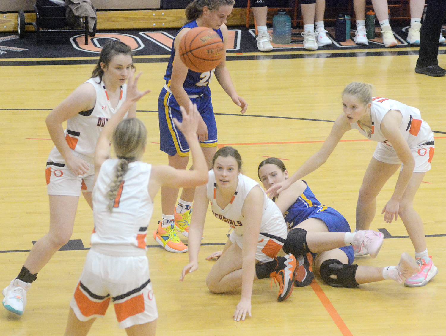 Kiana Guerrero (center) watches the ball sail into the waiting hands of Emma Daniels after she stole late in Owensville’s 63-32 season-opening girls basketball victory Monday night over the visiting St. Francis Borgia Lady Knights at Owensville High School.
